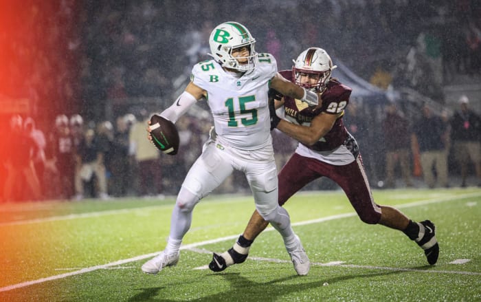 Mill Creek's KingJoesph Edwards has Buford's Dylan Raiola in his grasp.